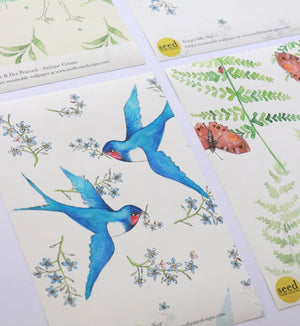 Forget Me Not wallpaper by Seed Home Designs in blue, flat sample of scattered forget-me-nots