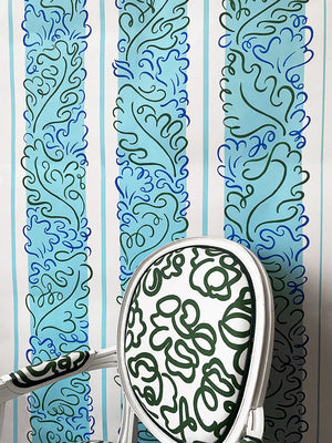 Sweet Memory wallpaper by Claire de Quénetain in blue and green, a hand-painted floral design in a styled room setting