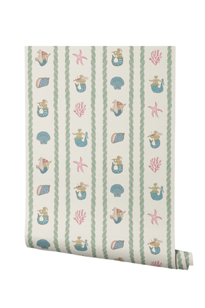 Swim Away With the Mermaids wallpaper by Annika Reed in cream and pink, partly unrolled roll showing shells and mermaids