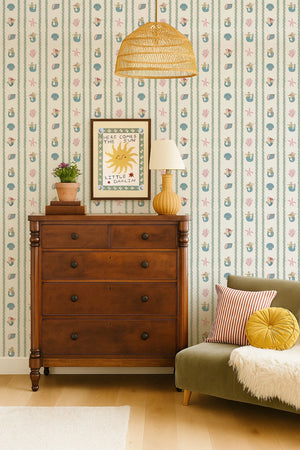 Swim Away With the Mermaids wallpaper by Annika Reed in cream and pink, shells and mermaids in a bedroom