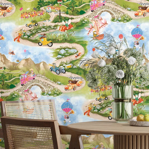 Tally Ho! wallpaper by Brand McKenzie in green and blue, a countryside landscape behind a dining table