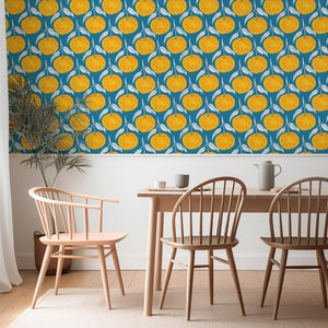 Clementine wallpaper by Seed Home Designs in blue, clementine slices behind a dining table
