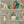 The Cabinet wallpaper by Brand McKenzie in cream, detail of a cabinet of curiosities