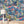 The Glitter Ranch wallpaper by Brand McKenzie in navy, a desert ranch scene above a sideboard