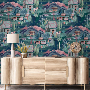 The Glitter Ranch wallpaper by Brand McKenzie in navy, a desert ranch scene above a cabinet