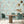 The Grand Pour wallpaper by Brand McKenzie in aqua, swimmers among cocktail glasses in a dining area