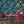 The Grand Pour wallpaper by Brand McKenzie in blue, swimmers among cocktail glasses behind a dining table