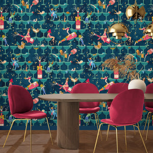 The Grand Pour wallpaper by Brand McKenzie in blue, swimmers among cocktail glasses behind a dining table