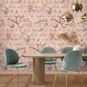 The Grand Pour wallpaper by Brand McKenzie in pink, swimmers among cocktail glasses behind a dining table