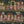 The Parlour wallpaper by Brand McKenzie in dark green, detail of ladies under salon hair dryers