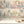 The Parlour wallpaper by Brand McKenzie in cream and pink, ladies under salon hair dryers behind a console table