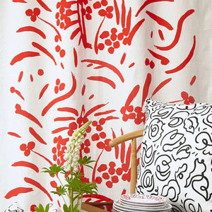 Red Bloom linen by Claire de Quénetain in red, draped, showing a hand-painted floral design