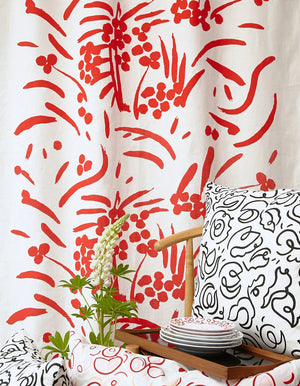 Red Bloom linen by Claire de Quénetain in red, draped, showing a hand-painted floral design