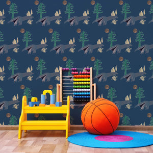 The Anteater wallpaper by Annika Reed in navy, anteaters and trees behind a daybed in a child's room