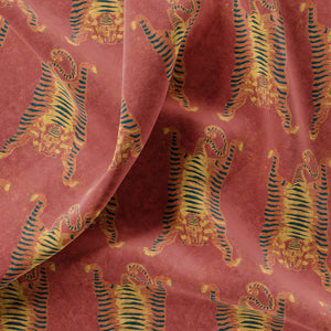 Tibetan Tiger velvet by Annika Reed in red and orange, draped, showing Tibetan tigers