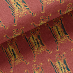 Tibetan Tiger linen by Annika Reed in red and orange, draped, showing Tibetan tigers