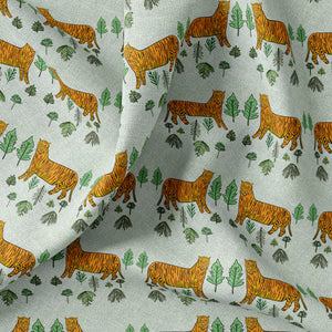 Tiger Tiger linen by Annika Reed in mint green and orange, draped close-up of tigers and trees