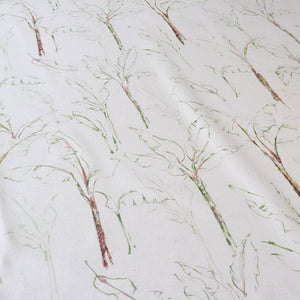 Tropical Paradise fabric by Seed Home Designs in green and beige, draped close-up of slender tropical stems