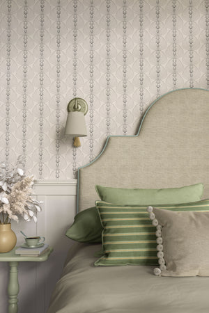 Tulip Medallion wallpaper by Dami and Em Design in parchment, tulip medallions behind an upholstered headboard