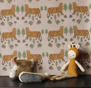 Tiger Tiger wallpaper by Annika Reed in pink and orange, tigers and trees above a sideboard