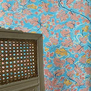 Veronique wallpaper by Claire de Quénetain in blue and pink, a hand-painted floral design in a styled room setting