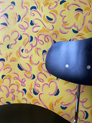 Victoire wallpaper by Claire de Quénetain in pink and blue, a hand-painted floral design in a styled room setting
