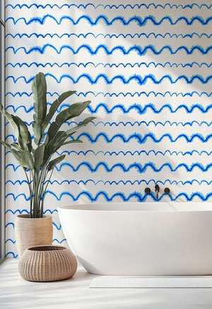 Wave After Wave wallpaper by Seed Home Designs in blue and white, wavy watercolour lines on a bathroom wall