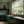 Wiggly Squiggly wallpaper by Annika Reed in green, wiggly waves behind bar stools
