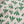 Wild linen by Bethie Tricks in green, draped close-up of block-print leaf sprigs