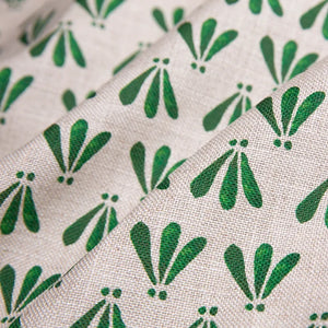 Wild linen by Bethie Tricks in green, draped close-up of block-print leaf sprigs