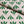 Wild linen by Bethie Tricks in green, in soft folds showing block-print leaf sprigs