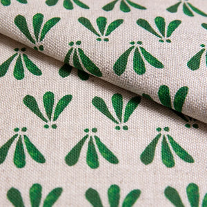 Wild linen by Bethie Tricks in green, in soft folds showing block-print leaf sprigs
