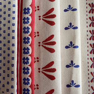 Wild linen by Bethie Tricks in pink, draped, showing block-print leaf sprigs