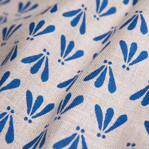 Wild linen by Bethie Tricks in blue, draped, showing block-print leaf sprigs