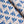 Wild linen by Bethie Tricks in blue, in soft folds showing block-print leaf sprigs
