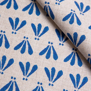 Wild linen by Bethie Tricks in blue, in soft folds showing block-print leaf sprigs
