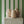 Wobble Large wallpaper by Annika Reed in green, wobbly stripes above a sideboard