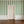 Wobble Large wallpaper by Annika Reed in green, wobbly stripes in a hallway