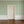 Wobble Small wallpaper by Annika Reed in green, wobbly stripes in a hallway