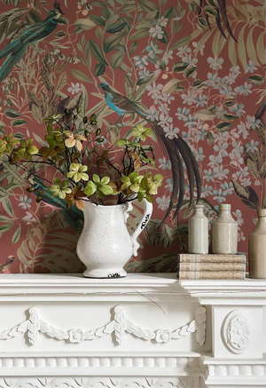 Resplendent Woods wallpaper by Deus ex Gardenia in teal, peacocks and pheasants in trees above a white mantelpiece