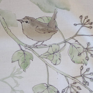 Wrens in the Ivy linen by Seed Home Designs in cream and green, draped close-up of wrens among ivy