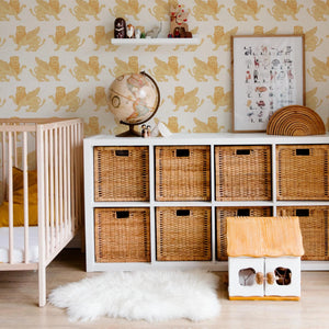 Winged Lion wallpaper by Annika Reed in mustard, winged lions behind a daybed in a child's room