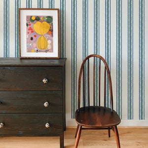 Zig and Zag wallpaper by Annika Reed in blue, zigzag stripes above a sideboard