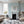 Zig and Zag wallpaper by Annika Reed in blue, zigzag stripes behind a sofa in a living room