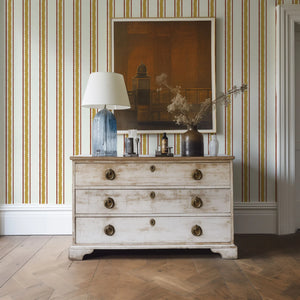 Zig and Zag wallpaper by Annika Reed in mustard, zigzag stripes behind a console table